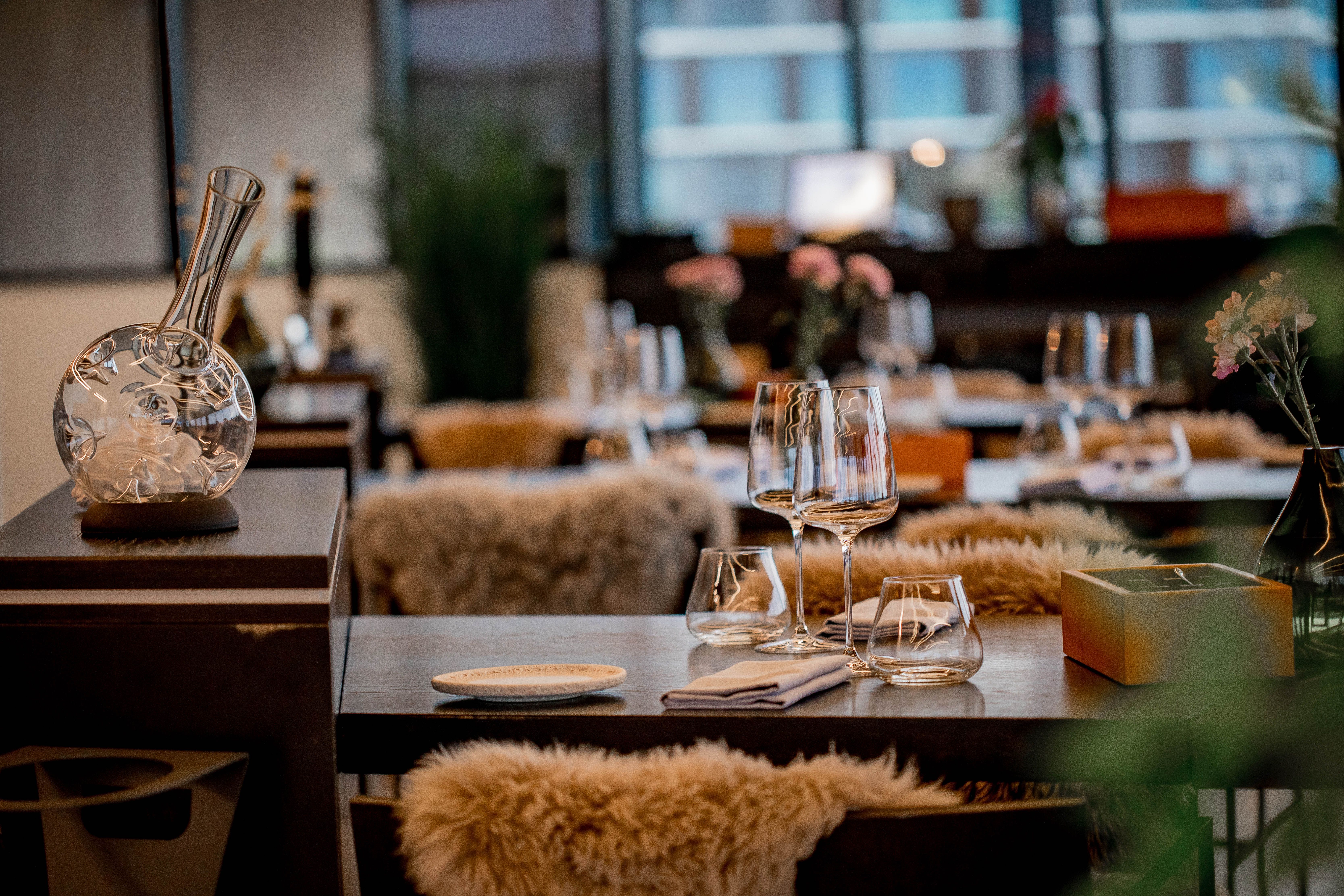 Elegant fine-dining table setting with glassware and warm restaurant lighting